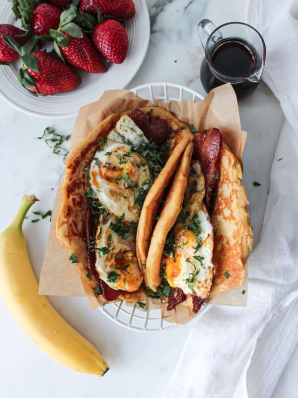 Breakfast pancake tacos with whole wheat pancakes, bacon and fried eggs.