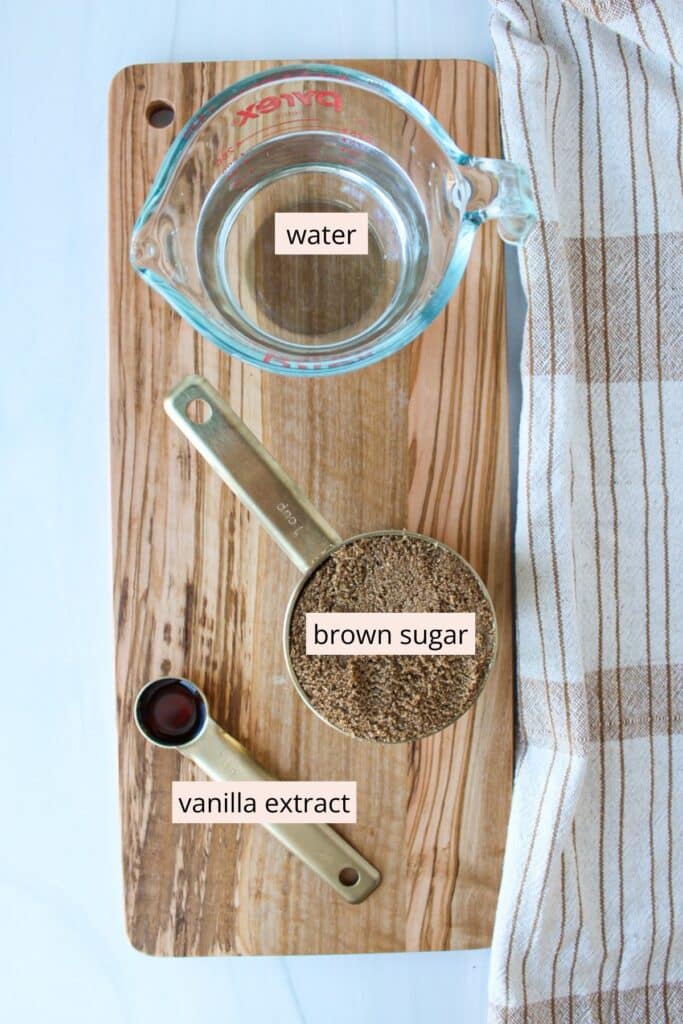 Water, brown sugar and vanilla extract in measuring containers.