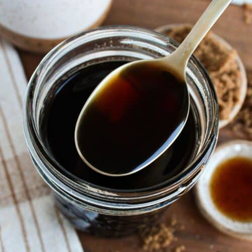 A close up shot of a spoonful of brown sugar syrup.