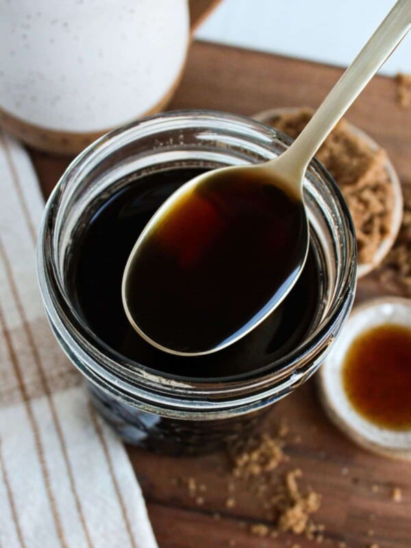 A close up shot of a spoonful of brown sugar syrup.