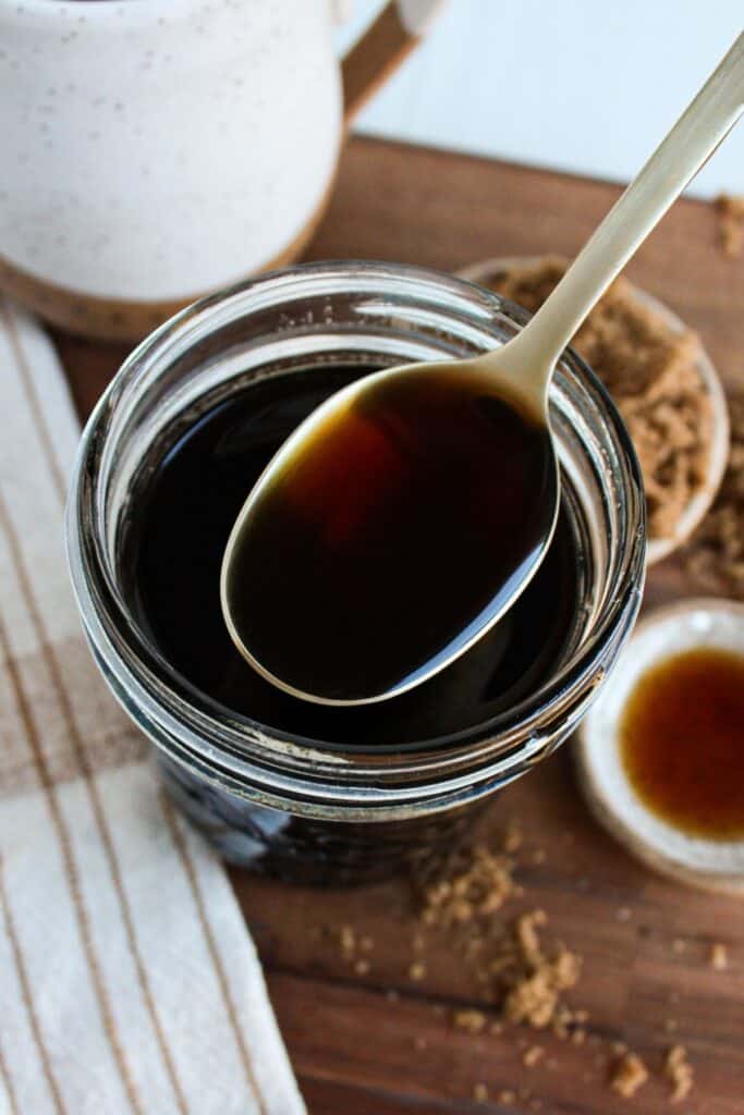 A close up shot of a spoonful of brown sugar syrup.