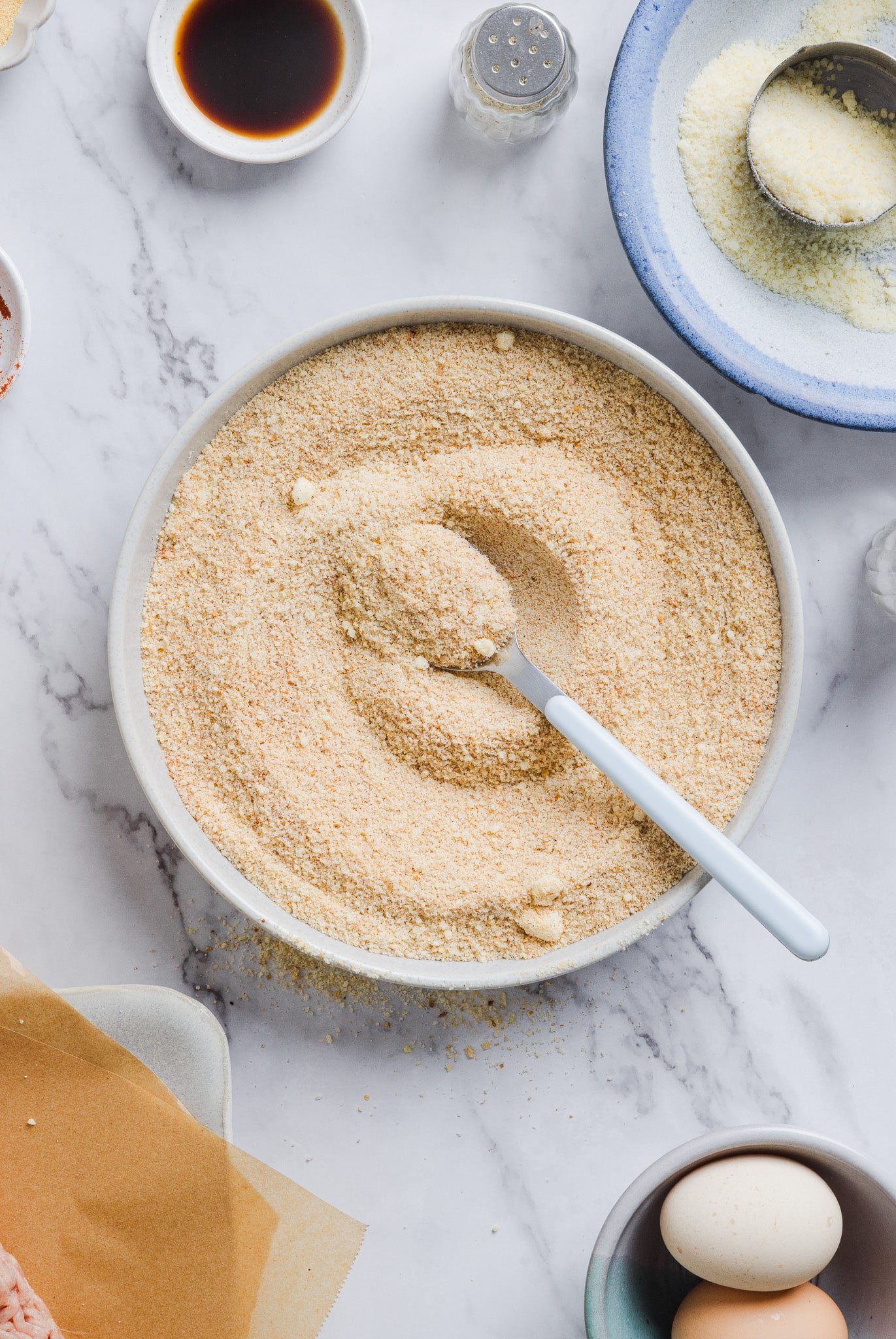 Breadcrumbs mixed with parmesan cheese in a bowl.