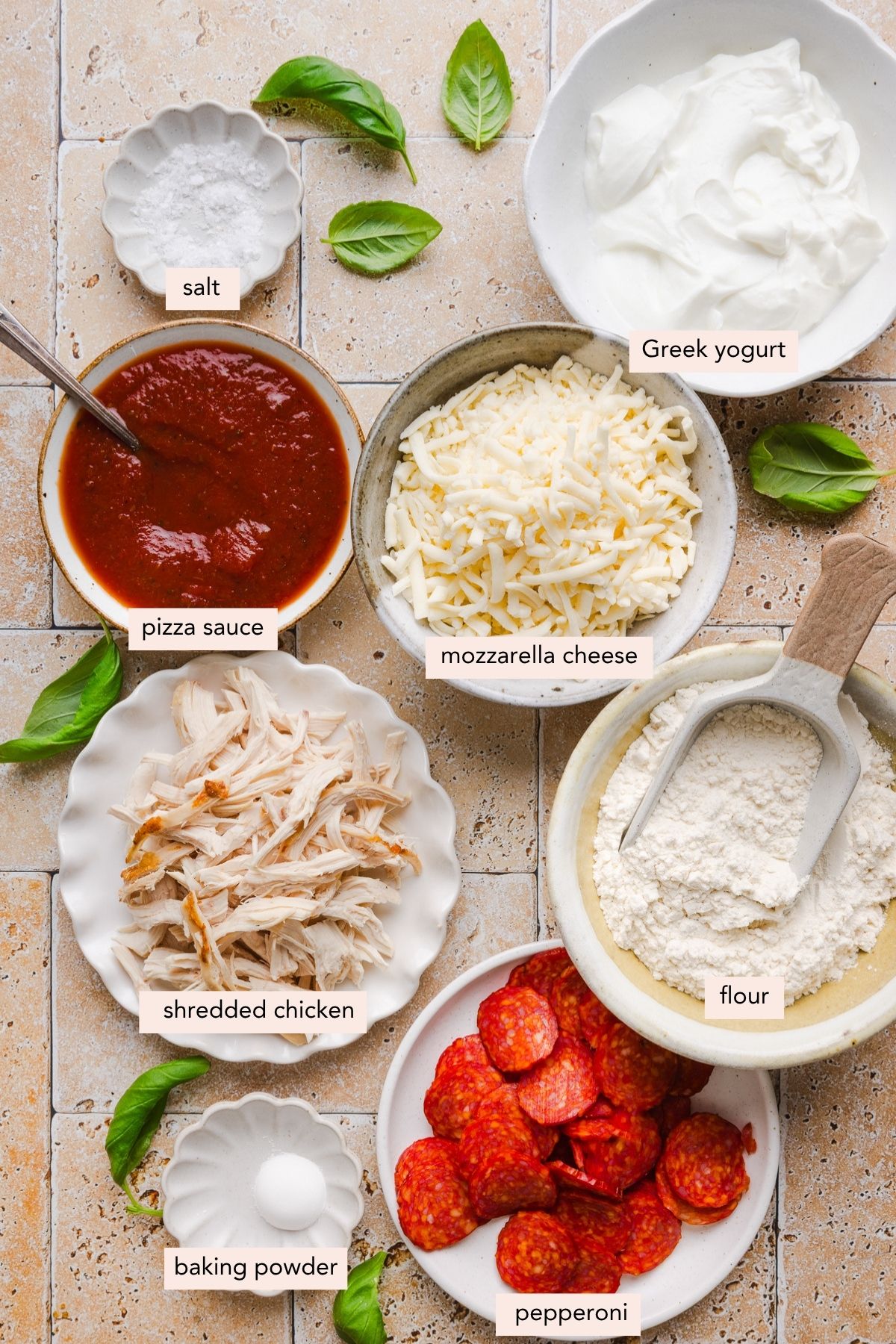 All of the ingredients for high protein pizza in bowls on a countertop.