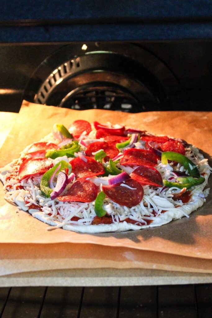 High protein pizza on a pan in the oven.