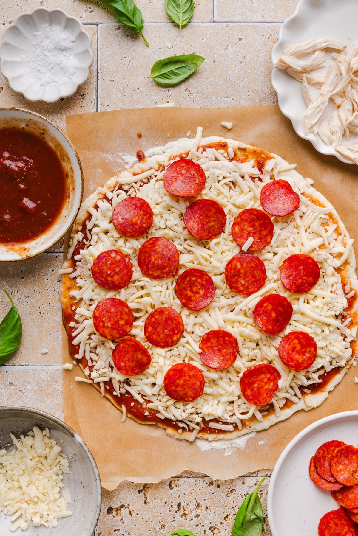 All of the toppings layered onto the pizza crust before baking.