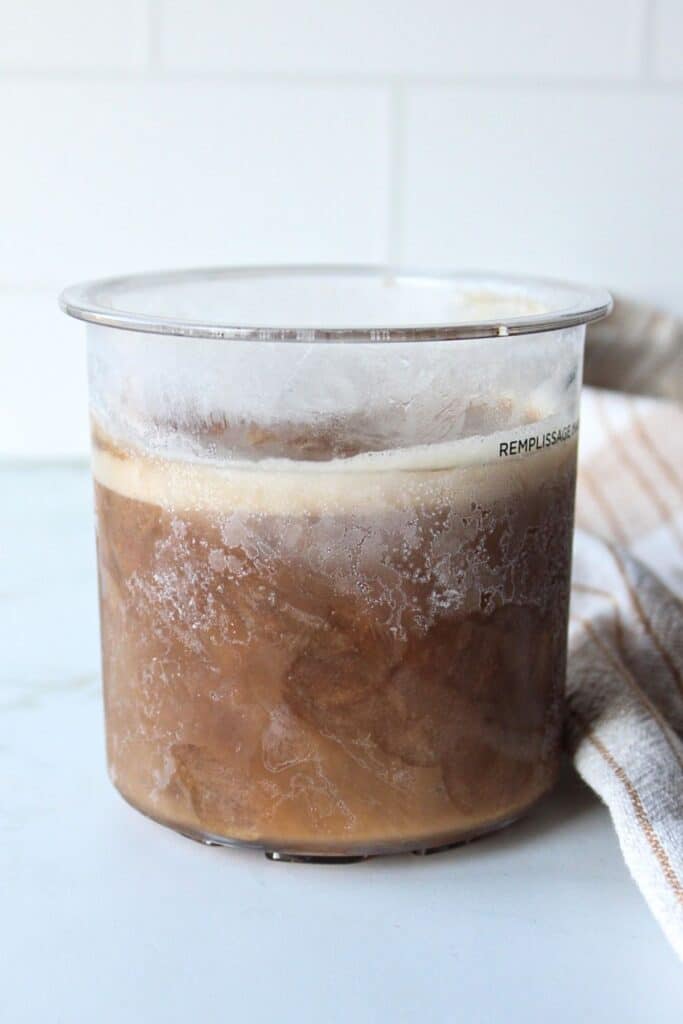 Frozen mixed ingredients in a ninja creami container.
