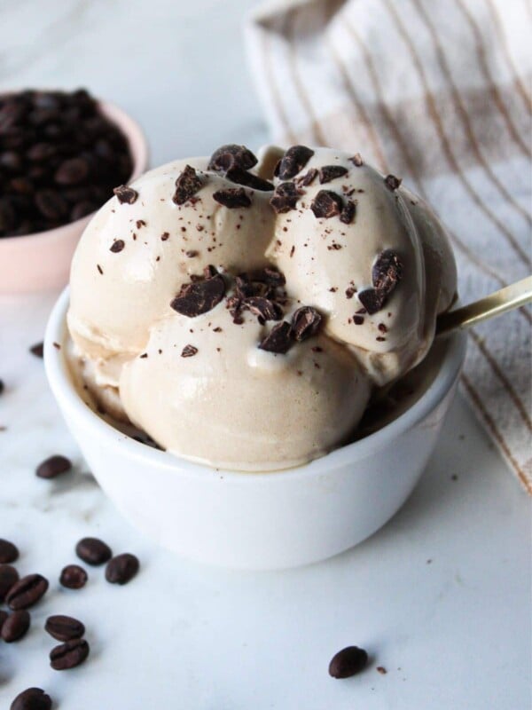Ninja creami coffee ice cream in a white bowl with chocolate chunks.