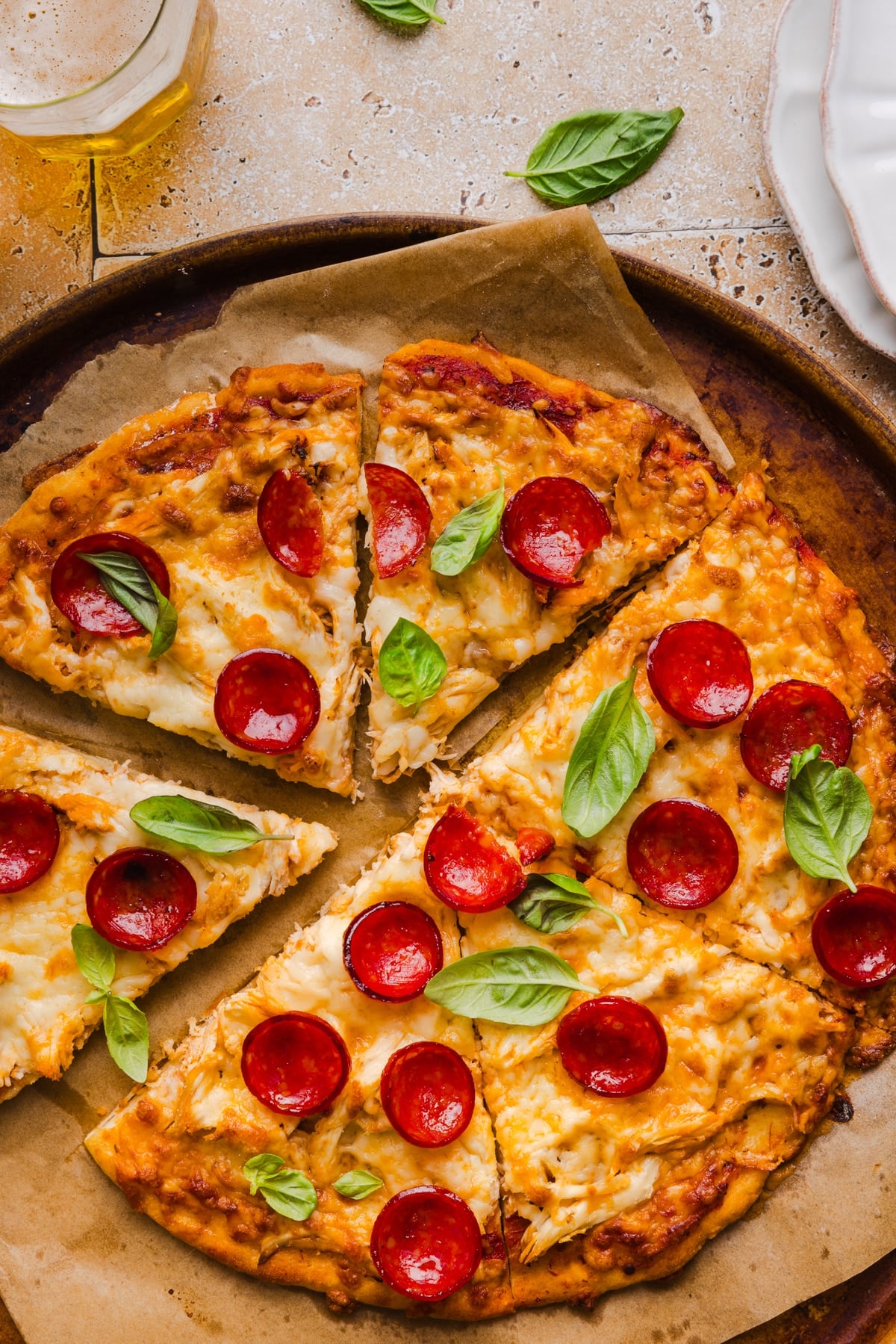 High protein pizza sliced into six pieces on the baking pan after baking.