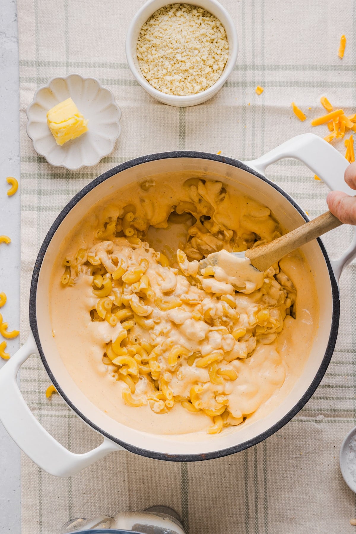 High protein cheese sauce being mixed with pasta.