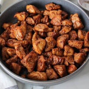 Cooked honey garlic chicken cubes in a grey bowl
