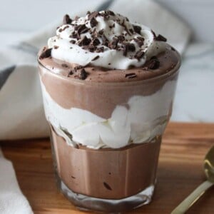 Cottage cheese chocolate mousse layered with whipped cream in a glass.