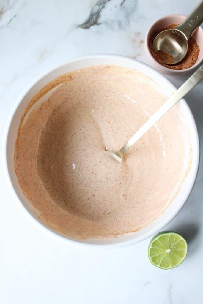 Greek yogurt taco sauce mixed up in a white bowl.