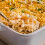 High protein Mac and cheese being scooped out of a baking dish.