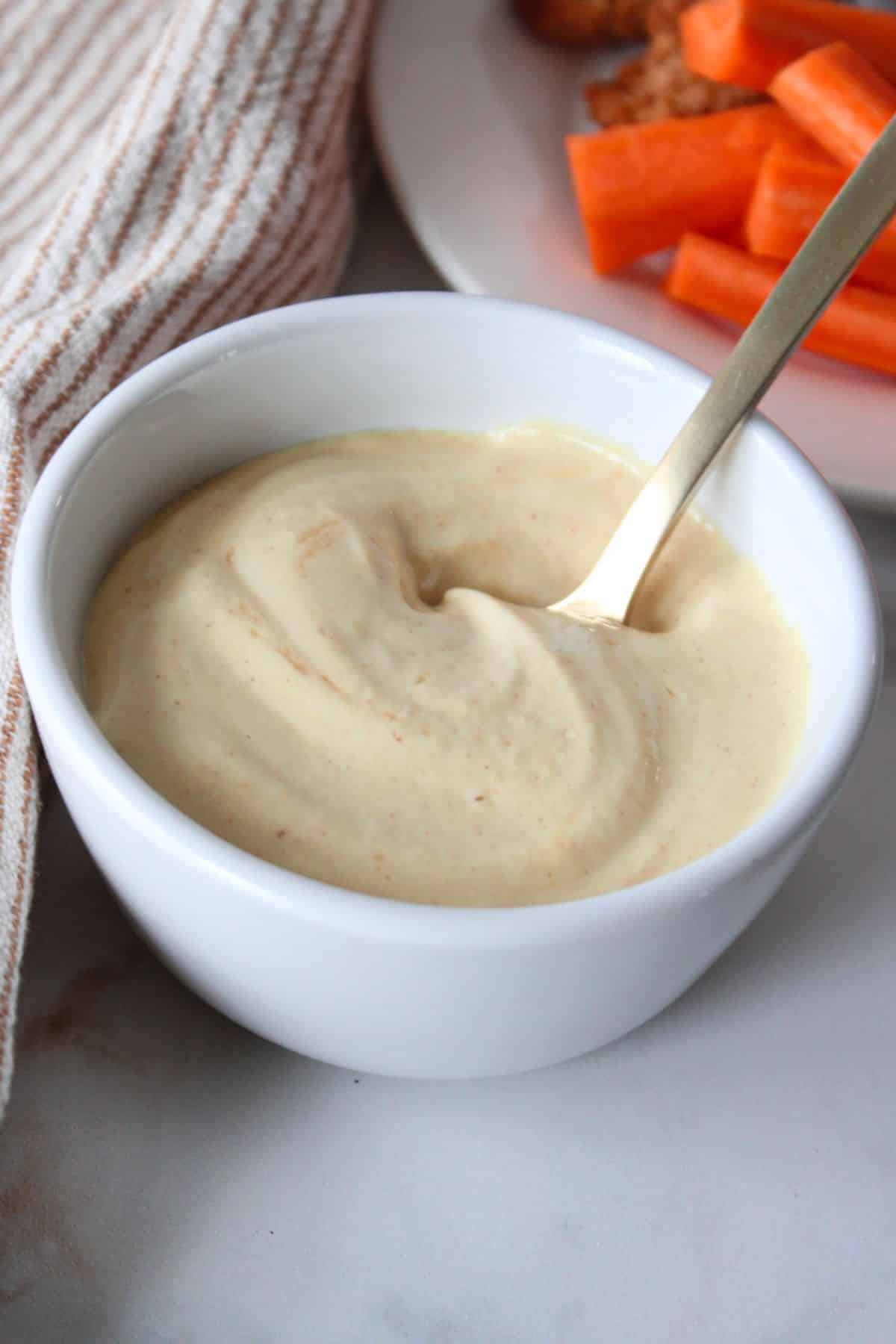 A white bowl of 3 ingredient honey mustard.