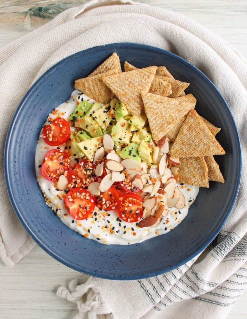 Blended cottage cheese topped with tomato avocado and served with crackers.