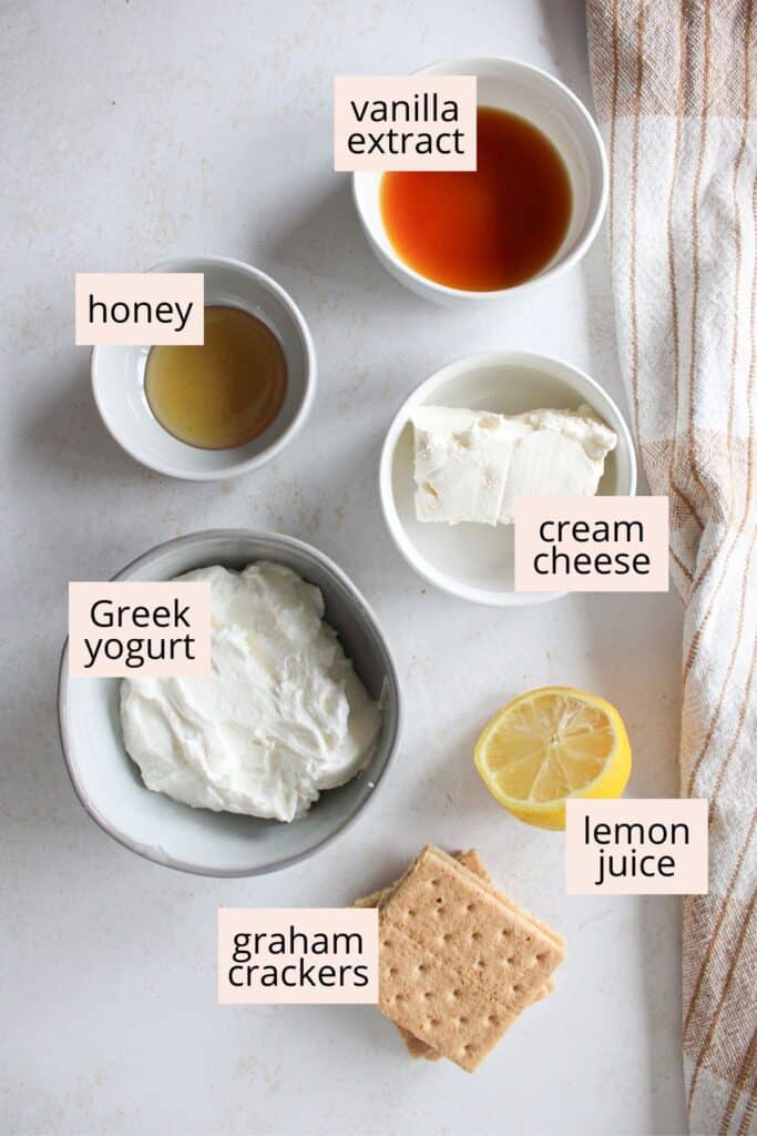 Ingredients for cheesecake fluff on a countertop with labels.