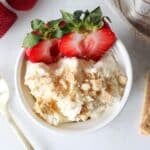 An overhead shot of cheesecake fluff with a gold spoon.