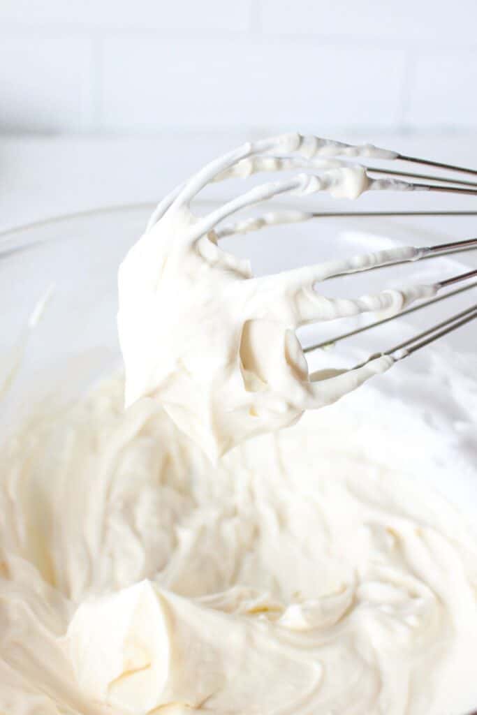 A whisk with cheesecake fluff.
