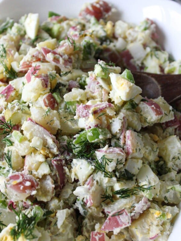 A close up shot of dill pickle potato salad.