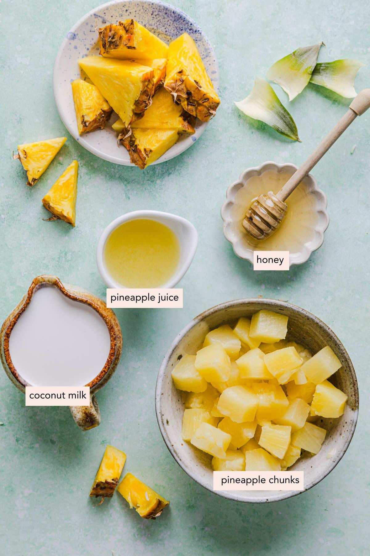 All of the ingredients for dole whip ninja creami in a bowls on a countertop.
