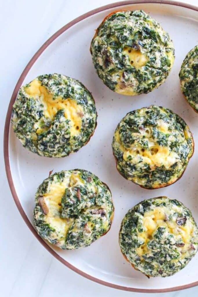 kale and mushroom egg bites on a plate.