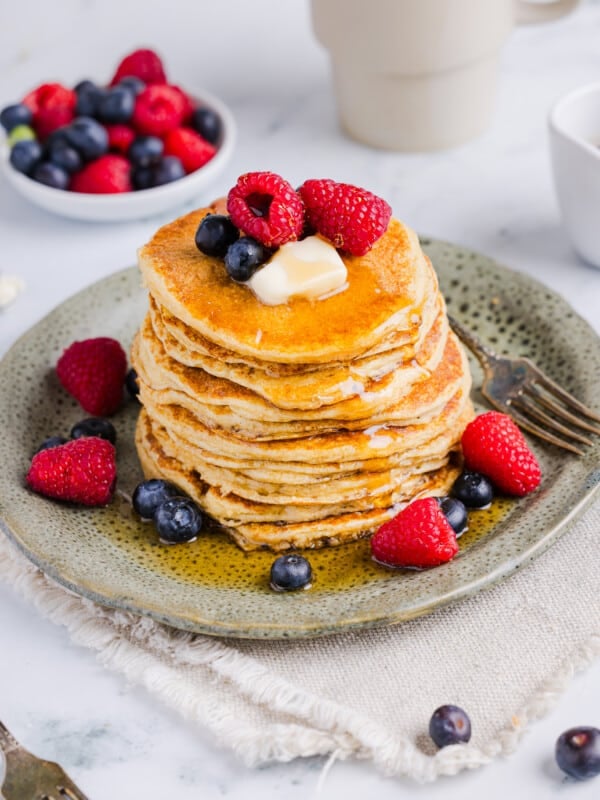 Oatmeal cottage cheese pancakes served with berries, butter and maple syrup.