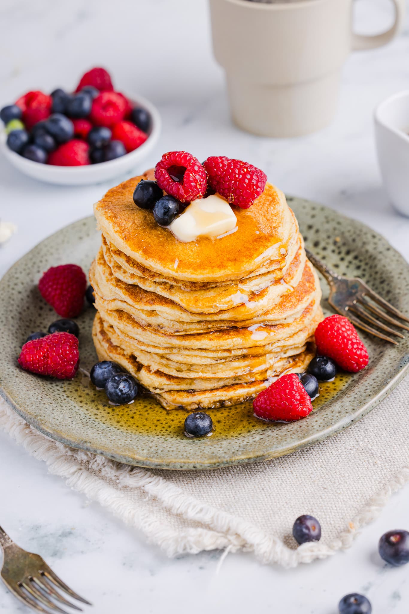 Oatmeal cottage cheese pancakes served with berries, butter and maple syrup.