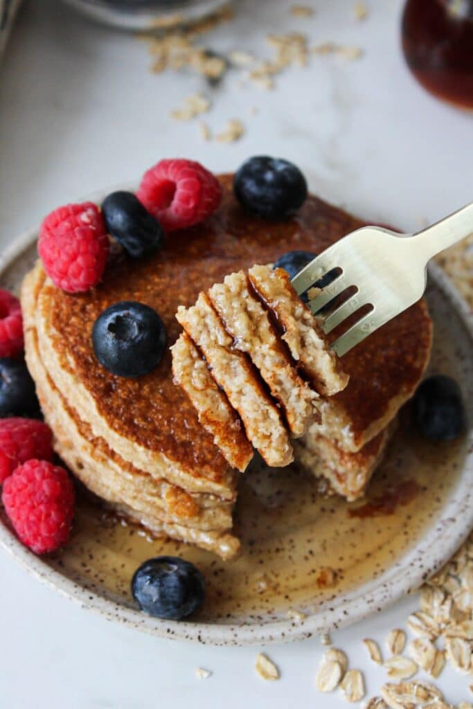 A close up shot of cottage cheese pancakes on a fork.
