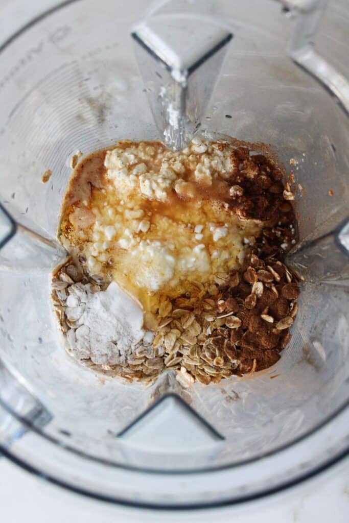 Ingredients for oatmeal cottage cheese pancakes in a blender.