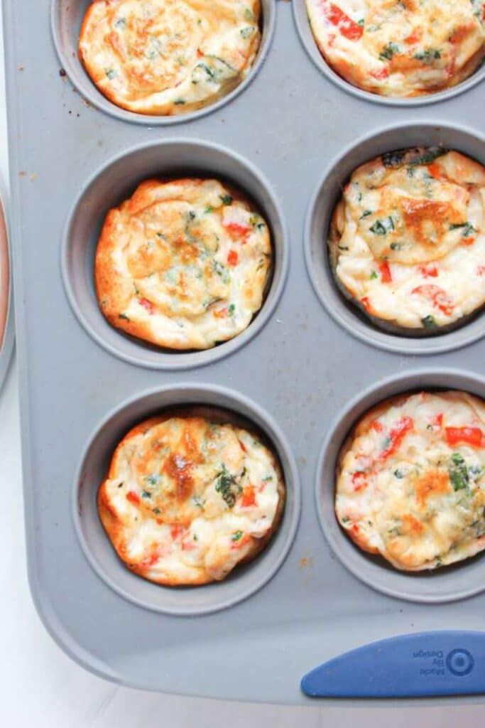 Red pepper egg white bites in a muffin pan.