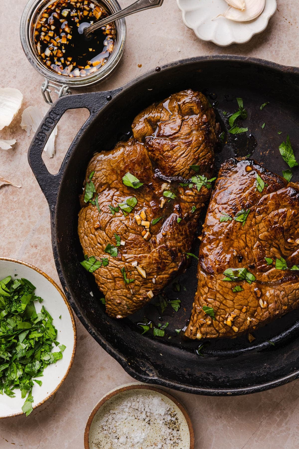 The marinated steak cooked in a cast iron pan.