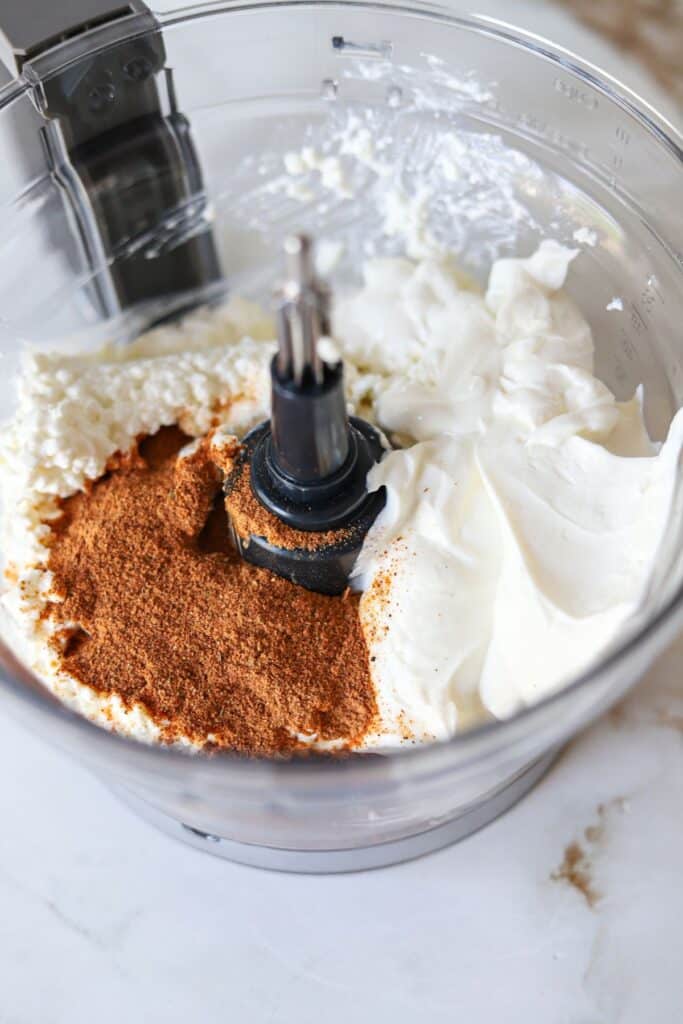 Cottage cheese, greek yogurt, taco seasoning and diced chiles in a food processor.