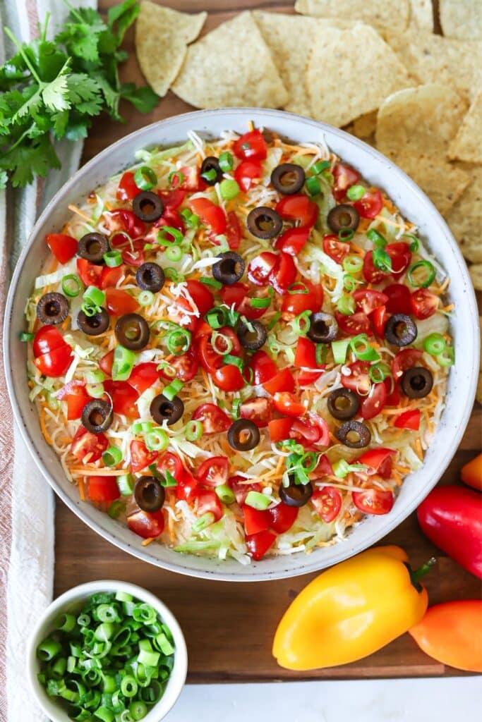 Cottage cheese taco dip topped with shredded lettuce, tomatoes and cheese.
