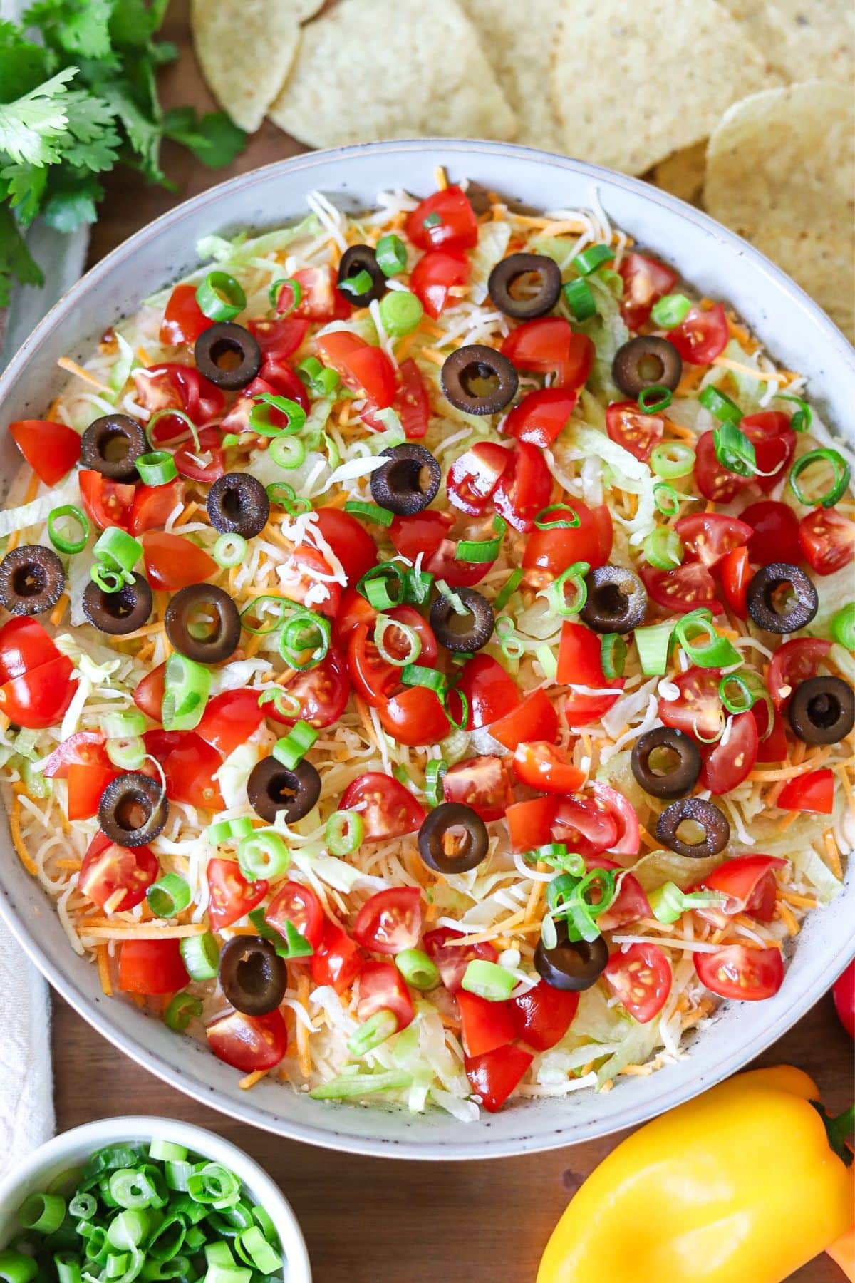 Cottage cheese taco dip topped with shredded lettuce, tomatoes and cheese.