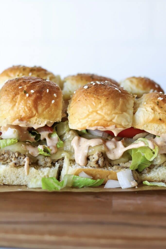 Ground turkey sliders with lettuce, tomato, pickles and burger sauce.
