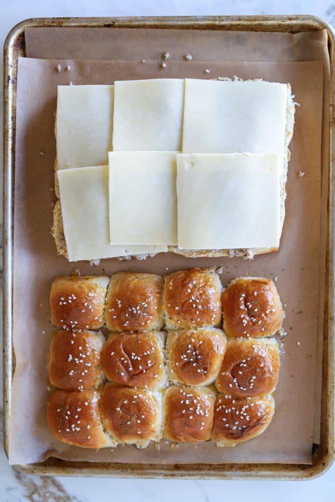 Slider rolls with ground turkey and sliced cheese.