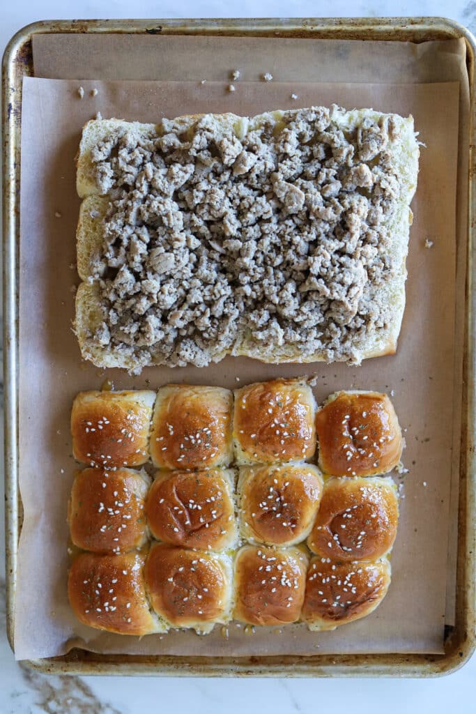 Slider rolls with cooked ground turkey.