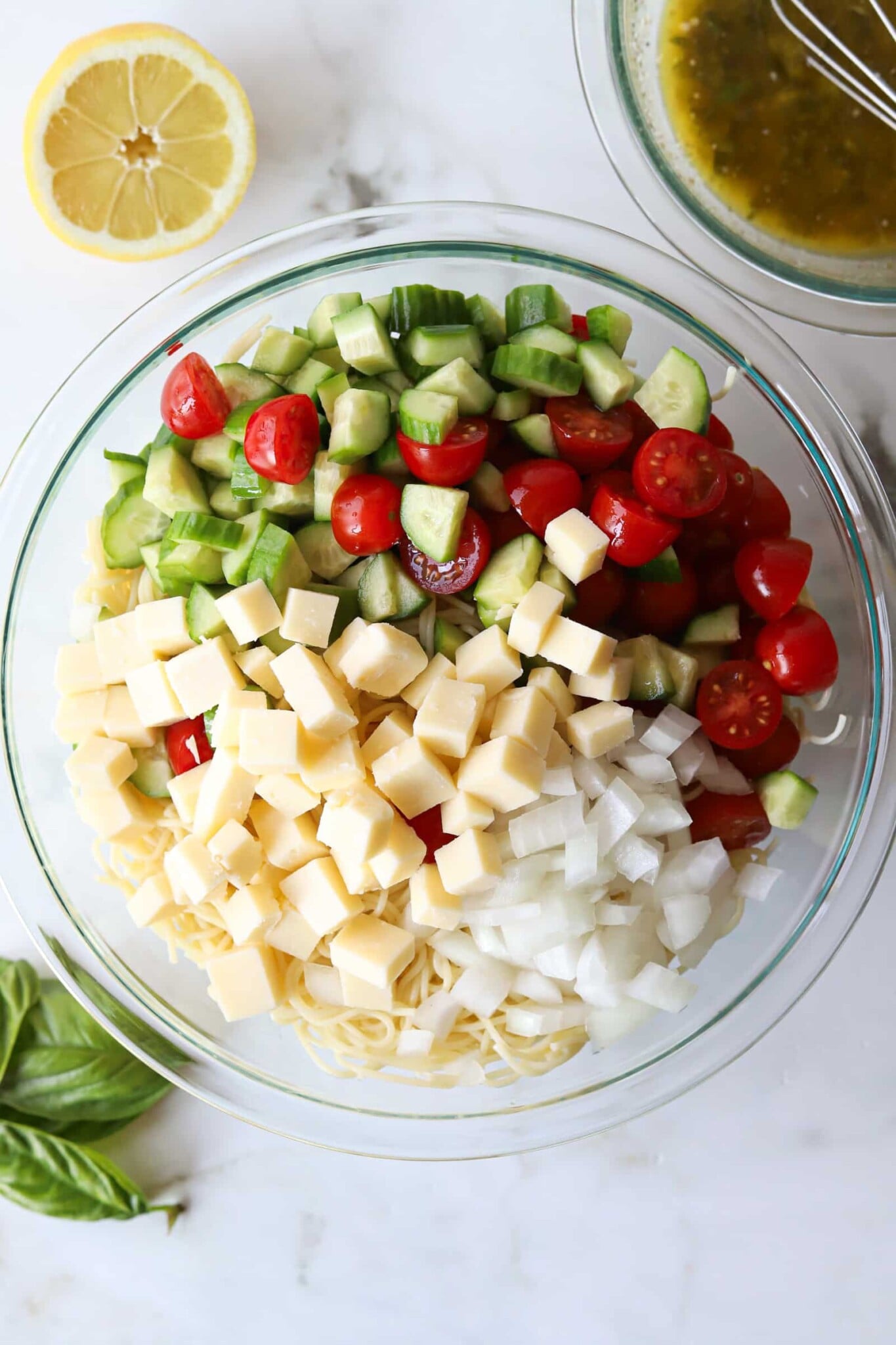 Ingredients for angel hair pasta salad in a bowl, not yet mixed.