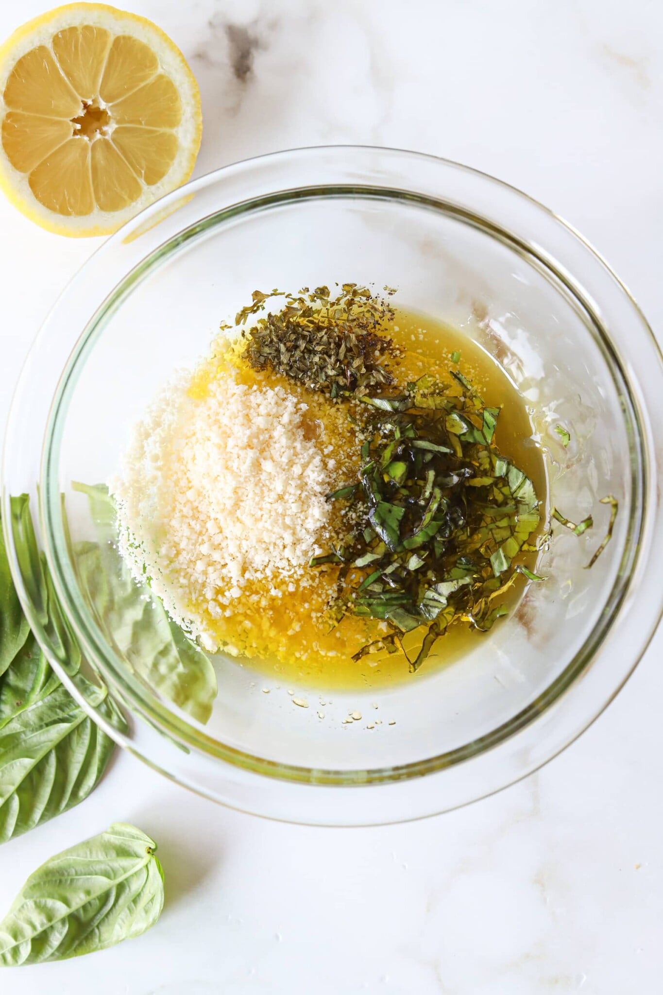 Ingredients for angel hair pasta salad dressing in a glass bowl.