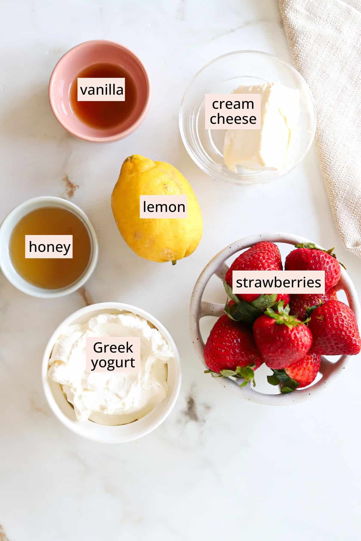 Ingredients for deviled strawberries on a countertop with labels.