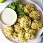 Garlic zucchini bites on a plate with ranch dressing.