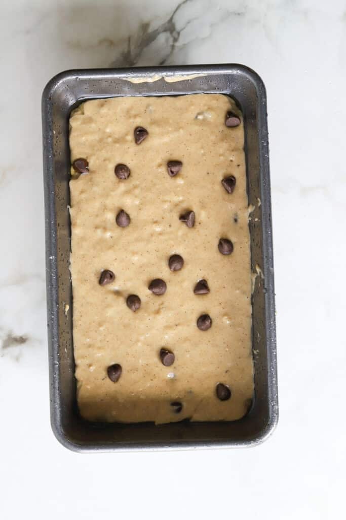 Kodiak banana bread batter with chocolate chips in a loaf pan.