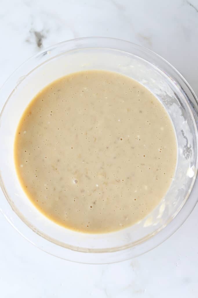 Wet ingredients for kodiak banana bread mixed together in a bowl.
