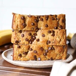 slices of banana bread stacked on a plate.