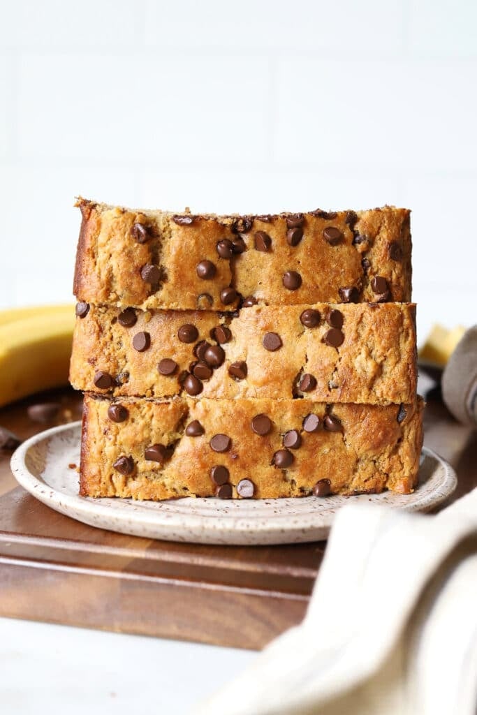slices of banana bread stacked on a plate.