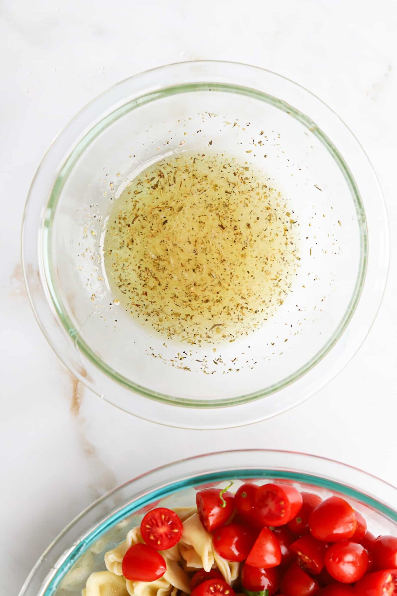 White balsamic vinaigrette mixed in a bowl for Caprese tortellini salad.