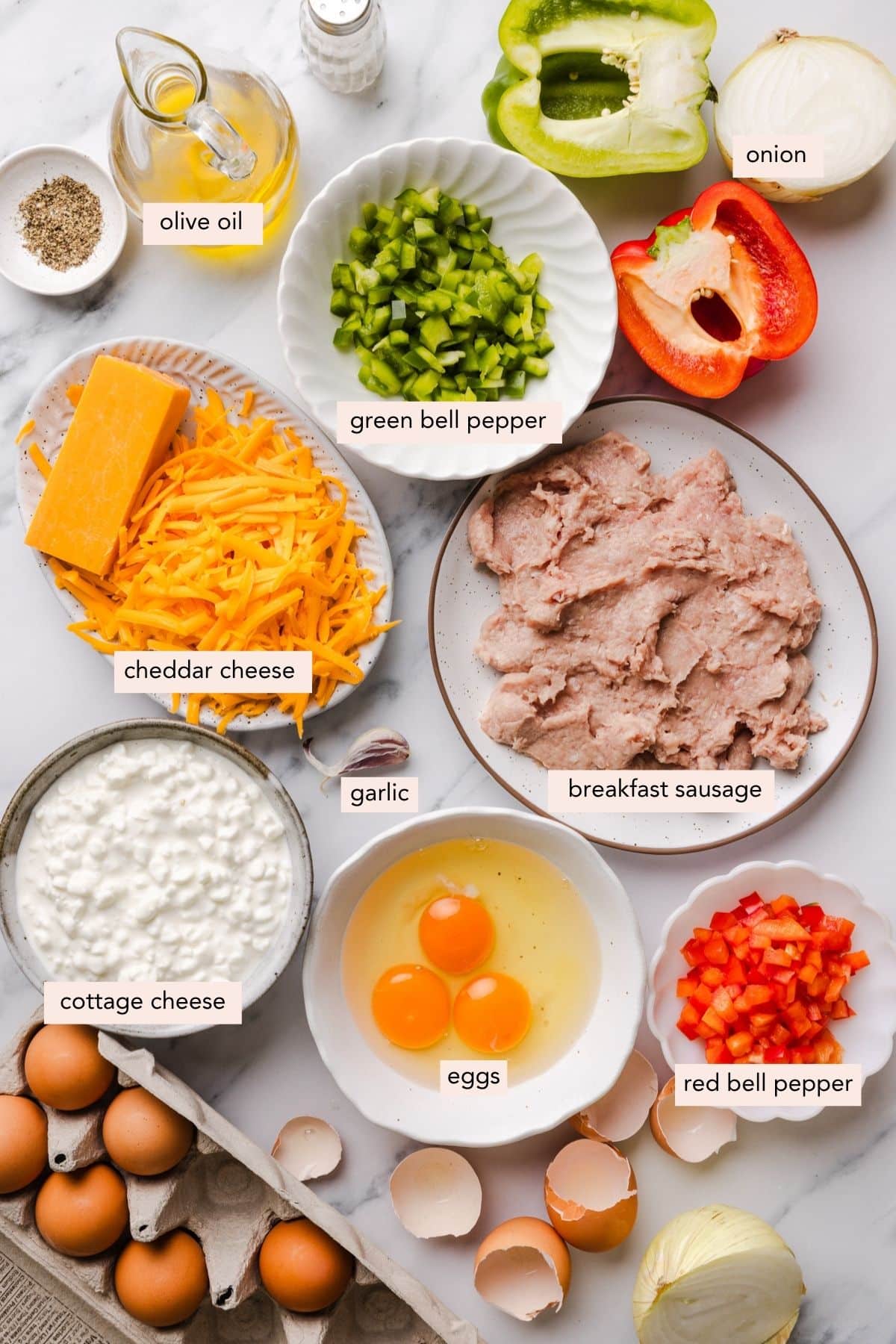 All of the ingredients for cottage cheese egg bake in bowls on a countertop.