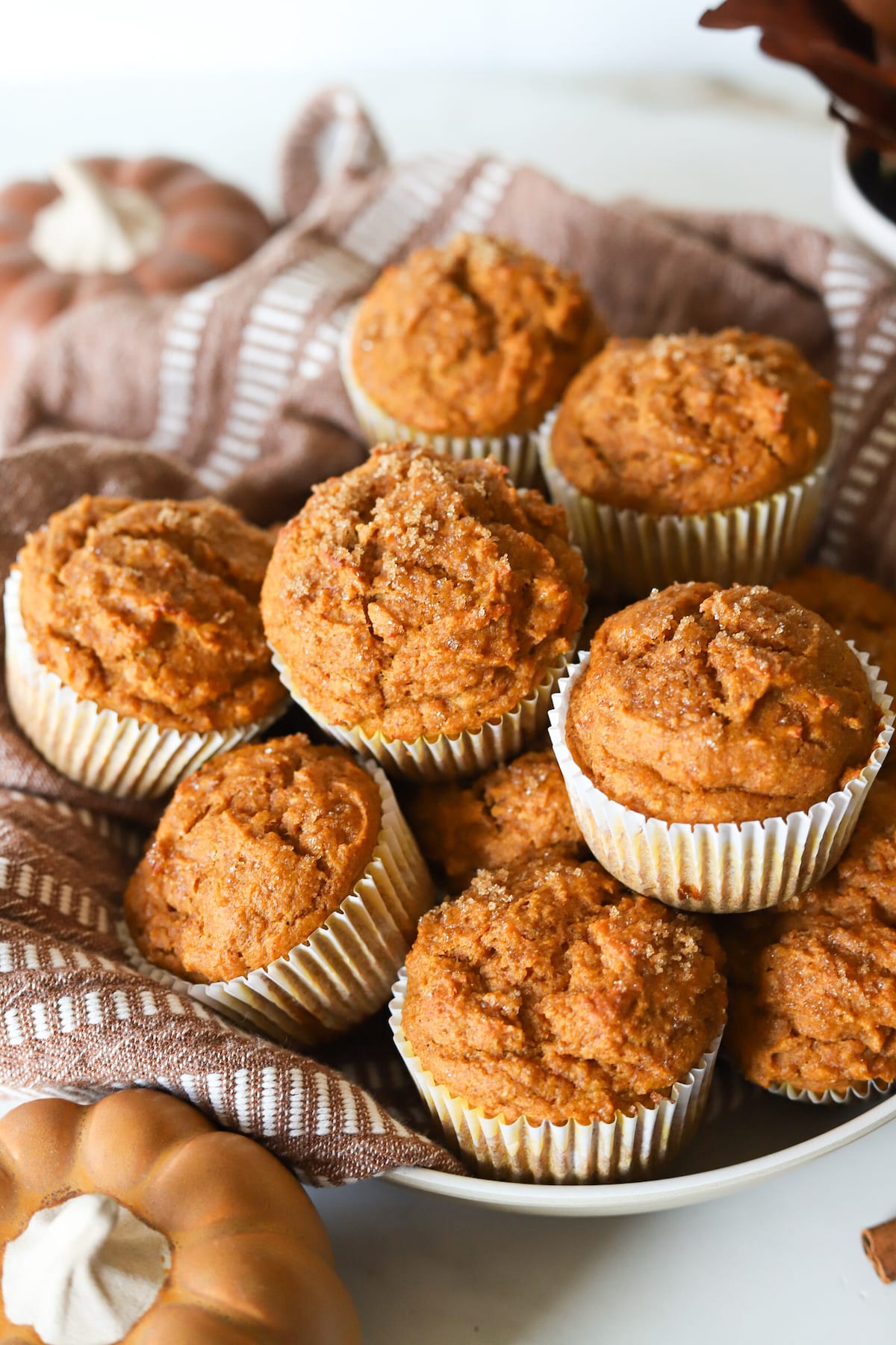 Kodiak pumpkin muffins in a bowl with a kitchen cloth.