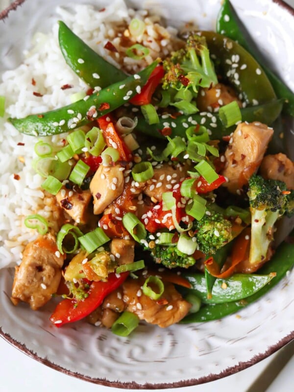 A teriyaki bowl with chicken, veggies, and white rice.