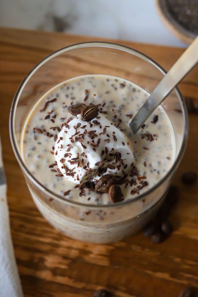 An overhead shot of coffee chia protein pudding topped with Greek yogurt and chocolate shavings.